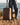 Photographer with camera and crossbody gear strap